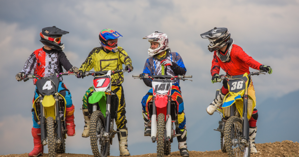 gorup of dirtbike riders talking about selling motorcycles
